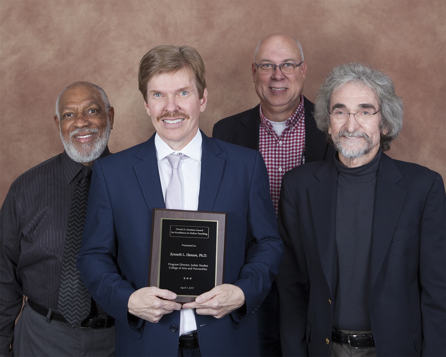 Lyman Brodie, Associate Dean, CAH (left), Kenneth L. Hanson (winner), Rick Brunson, and Chuck Dziuban
