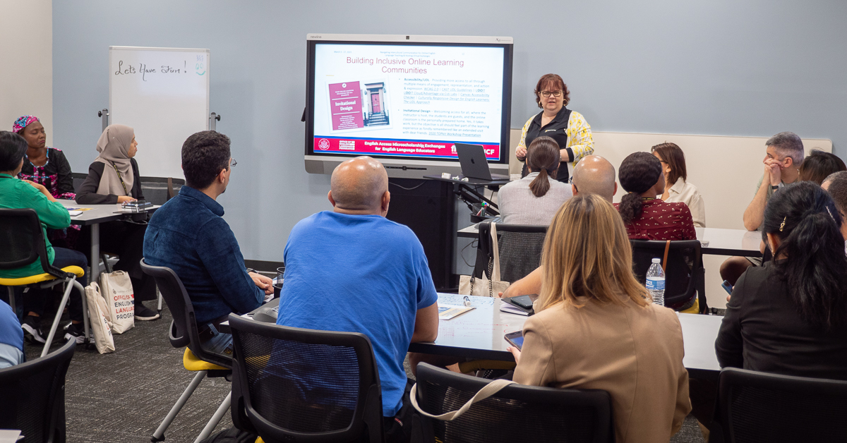 Woman gives a presentation to a group of people in the training room