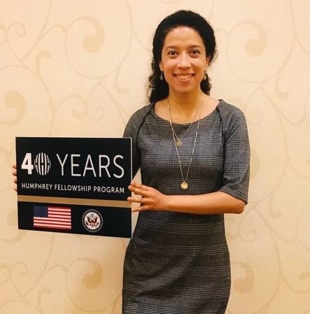 Woman in a dress holding a black sign that says 40 years 